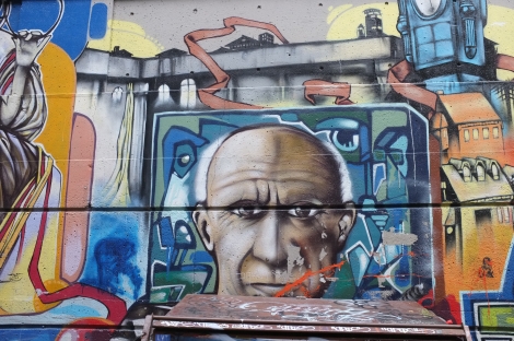 Close-up of a portrait of Picasso from the same alley